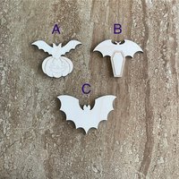 Handmade wood bat cutouts for Halloween crafts, available in three DIY styles