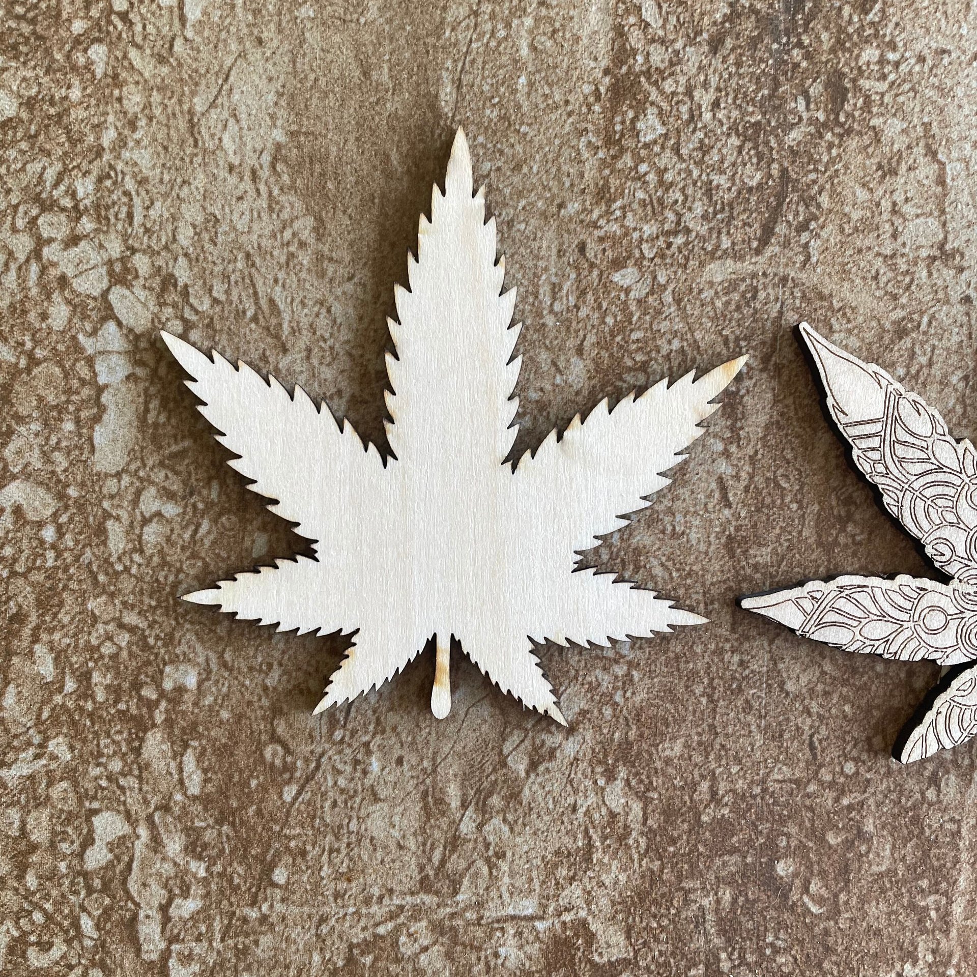 Handmade wooden DIY marijuana leaf cutout in two unique styles, ready for paint or decorating
